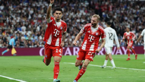 Bayern Munich's Colombian forward #14 Luis Diaz celebrates scoring the opening goal with Bayern Munich's Austrian midfielder #27 Konrad Laimer (R) during the UEFA Champions League quarter final first leg football match between Real Madrid CF and FC Bayern Munich at Santiago Bernabeu Stadium in Madrid on April 7, 2026.