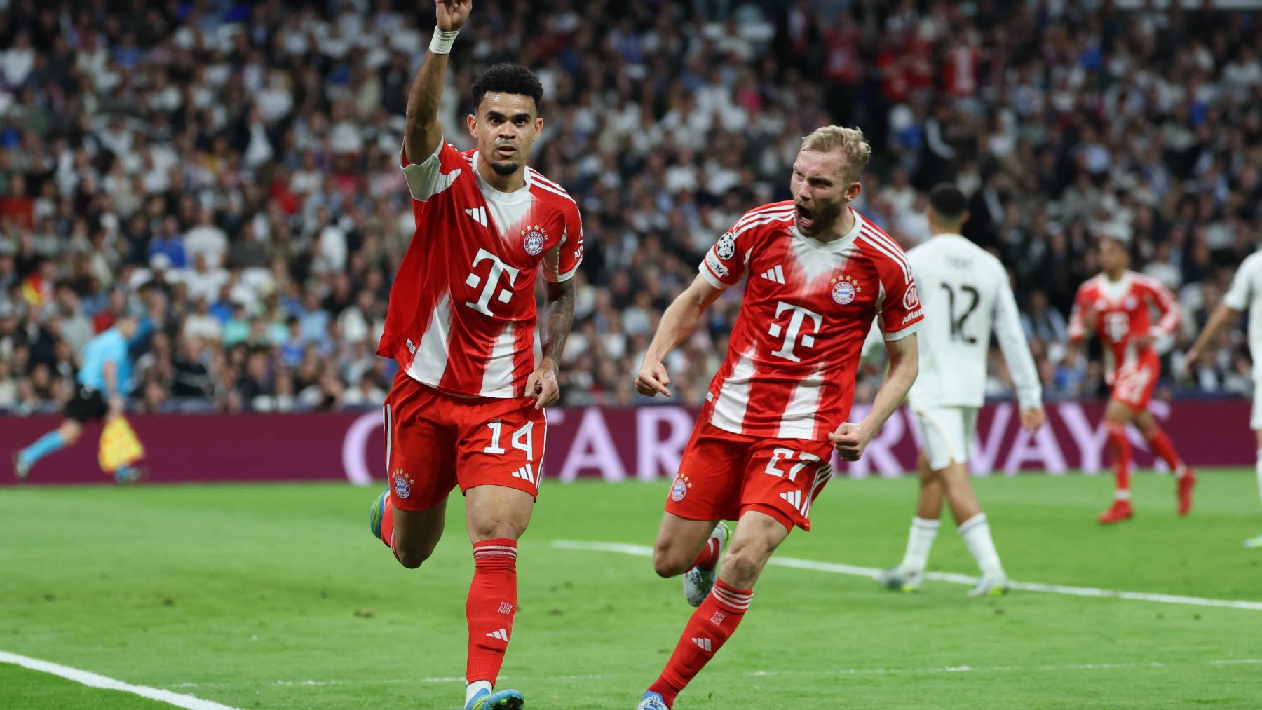 Bayern Munich's Colombian forward #14 Luis Diaz celebrates scoring the opening goal with Bayern Munich's Austrian midfielder #27 Konrad Laimer (R) during the UEFA Champions League quarter final first leg football match between Real Madrid CF and FC Bayern Munich at Santiago Bernabeu Stadium in Madrid on April 7, 2026.