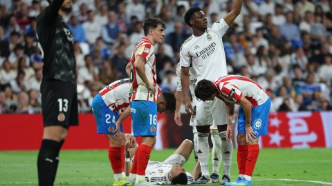 Real Madrid's French forward #10 Kylian Mbappe (C) lies on the pitch with blood on his face after colliding with Girona's Brazilian defender #12 Vitor Reis as Real Madrid's French midfielder #14 Aurelien Tchouameni requests assistance during the Spanish league football match between Real Madrid CF and Girona FC at the Santiago Bernabeu stadium in Madrid on April 10, 2026.