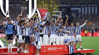 Real Sociedad's players celebrate with the trophy at the end the Copa del Rey (King's Cup) final football match between Club Atletico de Madrid and Real Sociedad at La Cartuja stadium in Seville on April 18, 2026. Real Sociedad won Atletico Madrid 4-3 on penalties.