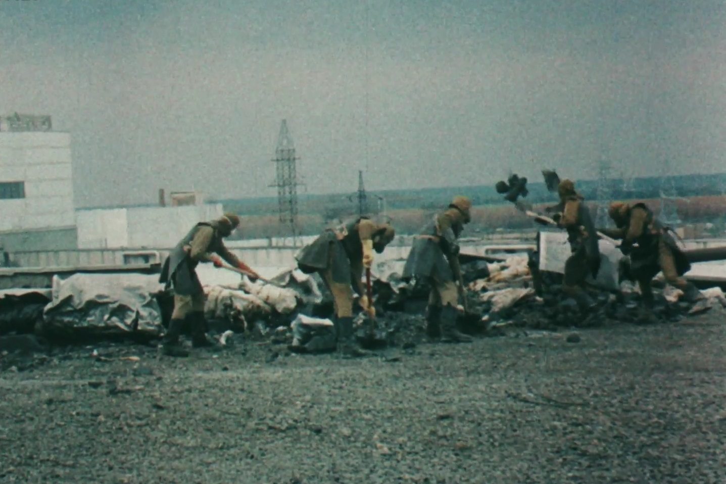 Likvidátorok lapátolják a sugárzó törmeléket a csernobili atomerőmű tetejéről.