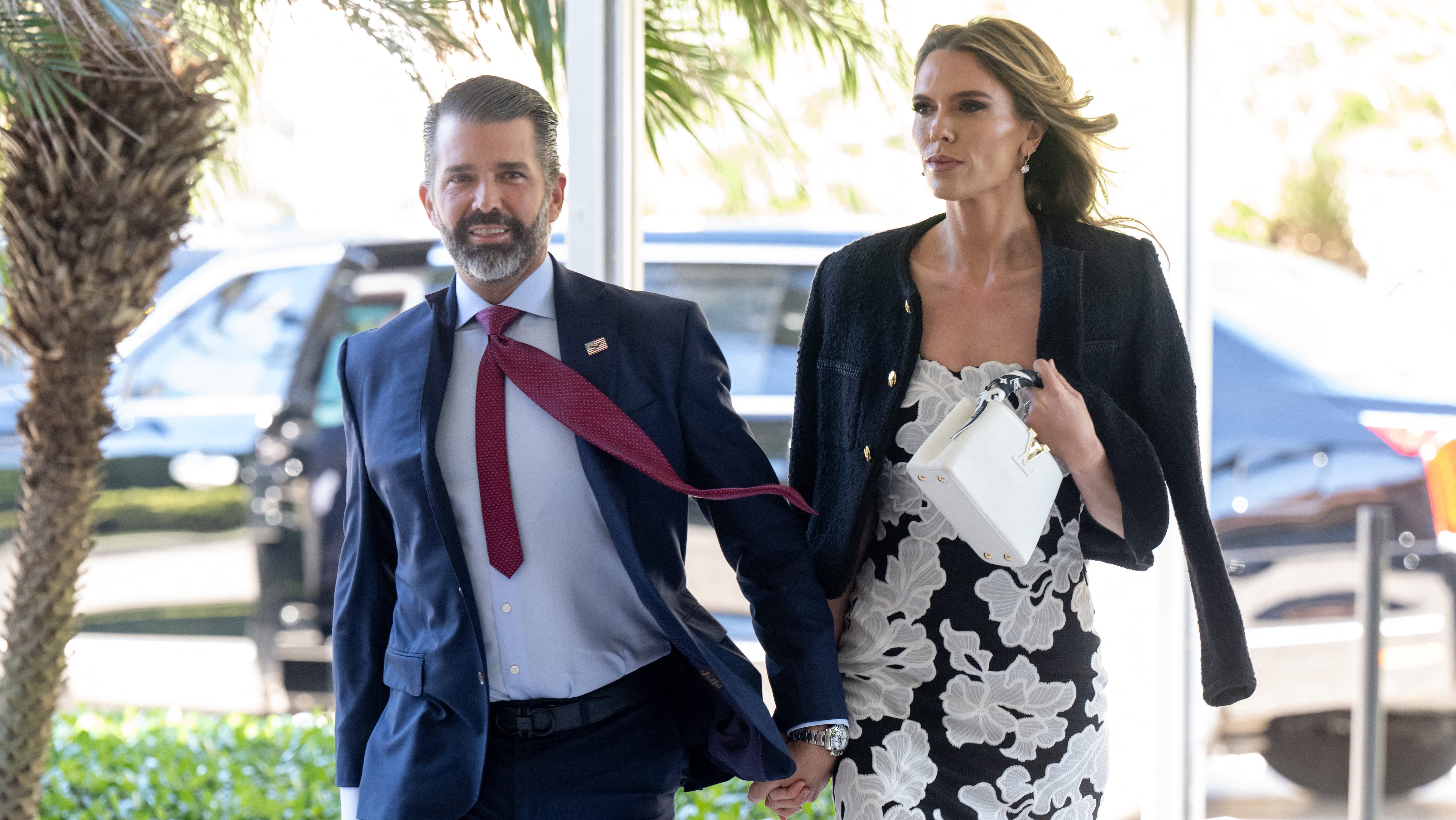 (L/R) Donald Trump Jr. and his fiancee Bettina Anderson arrive to attend the wedding of Dan Scavino, White House Deputy Chief of Staff, and Erin Elmore, the Department of State Director of Art in Embassies, at Mar-a-Lago in Palm Beach, Florida, February 1, 2026. (Photo by SAUL LOEB / AFP)