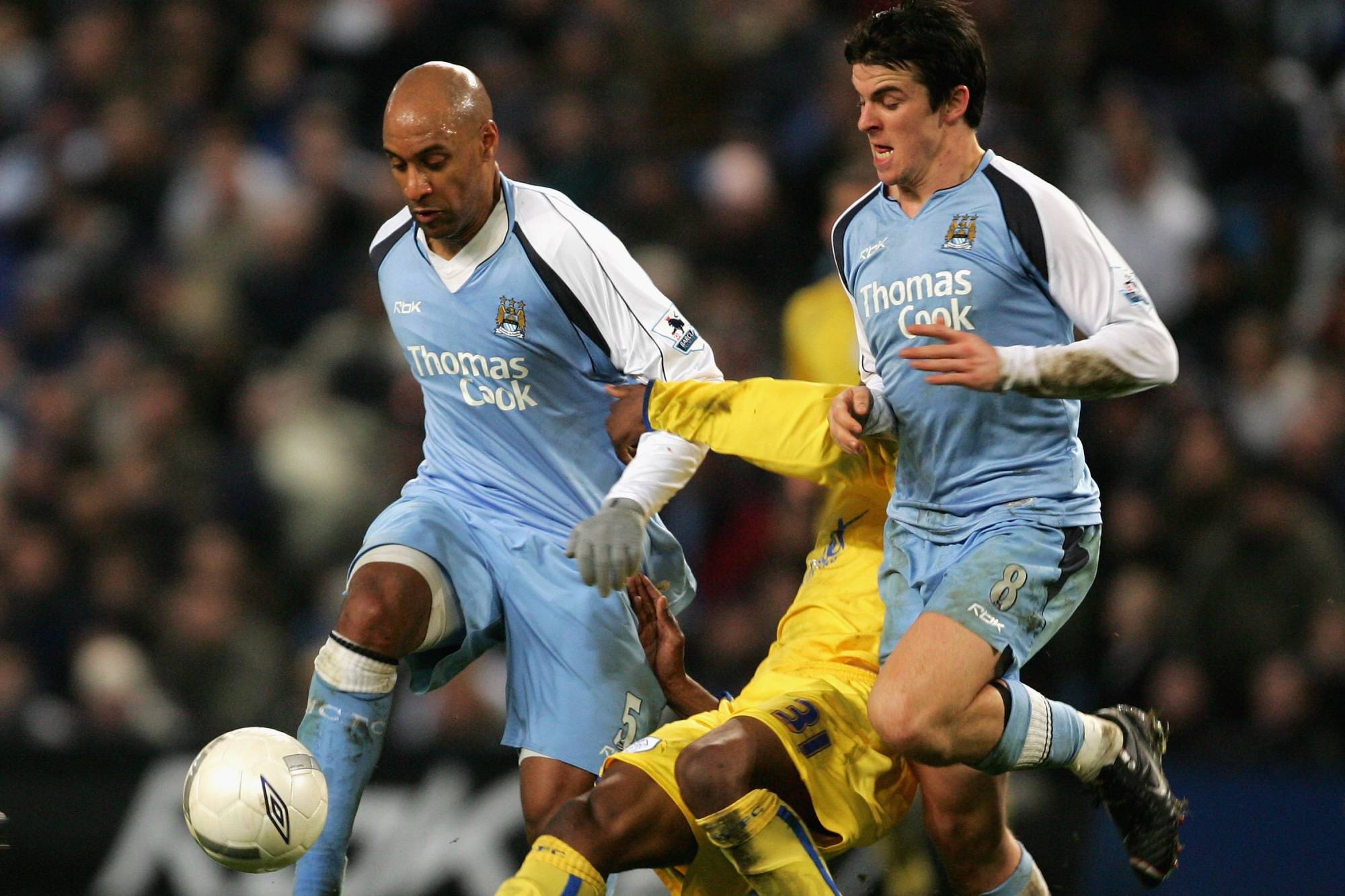 MANCHESTER, UNITED KINGDOM - JANUARY 16: Ousmane Dabo and Joey Barton of Manchester City clash with Yoanne Folly of Sheffield Wednesday during the FA Cup sponsored by E.ON Third Round replay match between Manchester City and Sheffield Wednesday at the City of Manchester Stadium on January 16, 2007 in Manchester, England. (Photo by Mark Thompson/Getty Images)