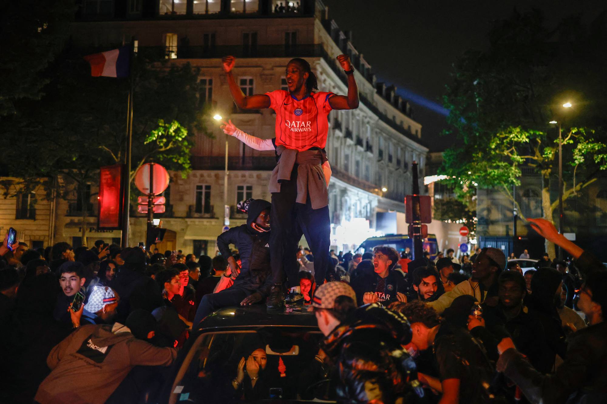 Paris Saint-Germain (PSG) supporters celebrate their team's progression to the Final of the UEFA Champions League near the Champs-Elysees after their second-leg semi-final football match against Bayern Munich, on May 6, 2026. The holders set up a Champions League final against Arsenal after a 1-1 second-leg draw at Bayern Munich secured a 6-5 aggregate victory.