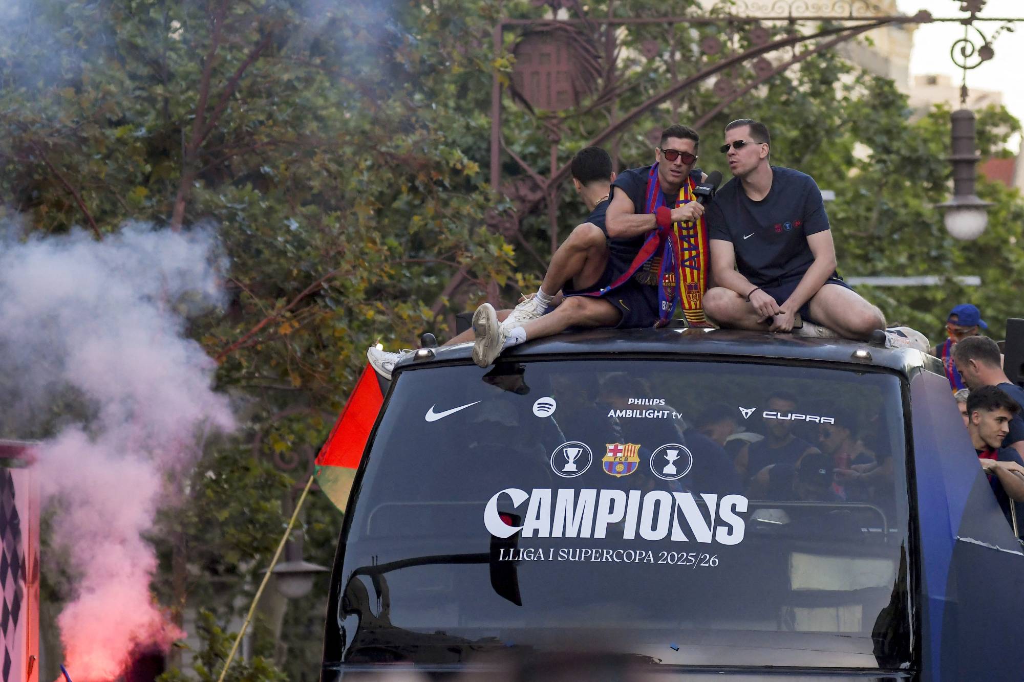 BARCELONA, SPAIN - MAY 11: Players of FC Barcelona celebrate winning the 2025/26 LaLiga and Supercopa de Espana titles with supporters in the streets of Barcelona, Spain, on May 11, 2026. Adria Puig / Anadolu (Photo by Adria Puig / Anadolu via AFP)