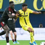 Sevilla's Nigerian forward #09 Akor Jerome Adams challenges Villarreal's US defender #03 Alexander Freeman during the Spanish league football match between Villarreal CF and Sevilla FC at La Ceramica Stadium in Vila-real on May 12, 2026.