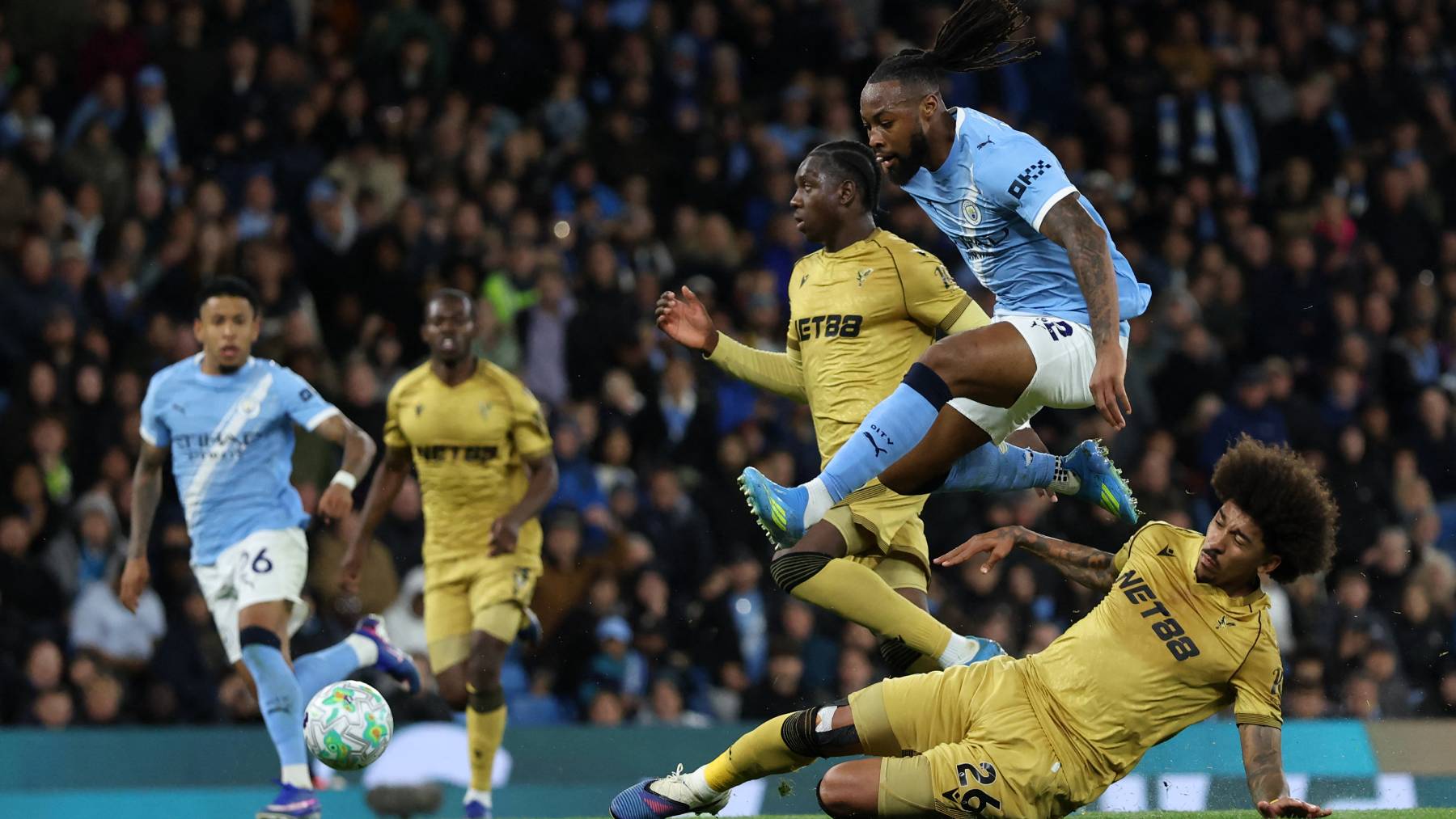 Manchester City's Ghanaian midfielder #42 Antoine Semenyo jumps a challenge from Crystal Palace's US defender #26 Chris Richards during the English Premier League football match between Manchester City and Crystal Palace at the Etihad Stadium in Manchester, north west England, on May 13, 2026.