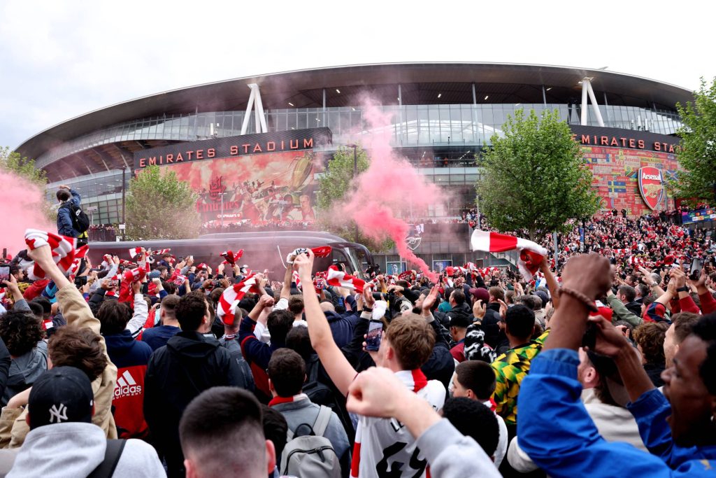 Arsenal fans welcome the team bus with flares and scarves before the UEFA Champions League second-leg semi-final football match between Arsenal and Atletico Madrid at the Emirates Stadium in north London on May 5, 2026.