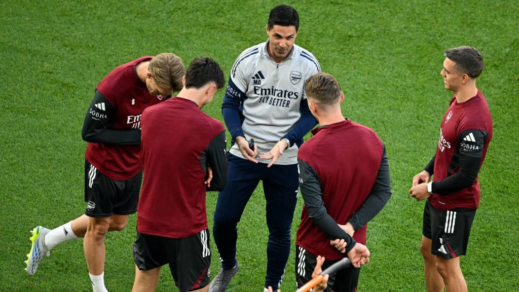Arsenal's Spanish manager Mikel Arteta (C) speaks with players during a MD-1 training session at the Puskas Arena in Budapest on May 29, 2026, on the eve of the UEFA Champions League final football match between Paris Saint-Germain (PSG) and Arsenal FC. Paris Saint-Germain (PSG) face Arsenal in the UEFA Champions League final football match on May 30, 2026 in Budapest.