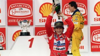 Brazilian Formula One driver Ayrton Senna pours champagne over himself on March 28, 1993 celebrating his victory in the Brazilian Grand Prix, Sao Paulo. This was Senna's 37th Grand Prix victory, but only his second win in Brazil. In back is German driver Michael Schumacher.