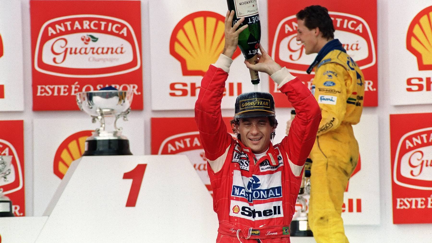 Brazilian Formula One driver Ayrton Senna pours champagne over himself on March 28, 1993 celebrating his victory in the Brazilian Grand Prix, Sao Paulo. This was Senna's 37th Grand Prix victory, but only his second win in Brazil. In back is German driver Michael Schumacher.