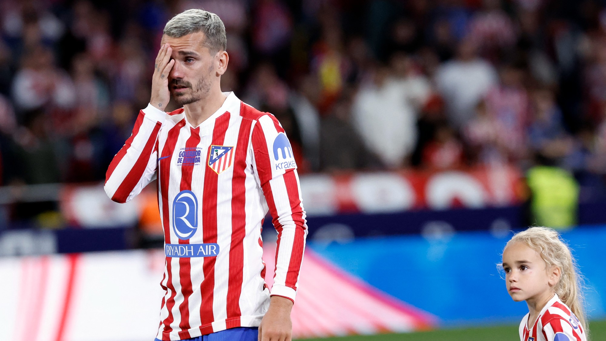 Atletico Madrid's French forward #07 Antoine Griezmann gets emotional next to one of his children during a farewell ceremony after the Spanish league football match between Club Atletico de Madrid and Girona FC at the Metroplitano stadium in Madrid on May 17, 2026. French forward Antoine Griezmann received a warm goodbye from the club's supporters today. Atletico's all-time top goalscorer will head to the United States to play for MLS side Orlando City.