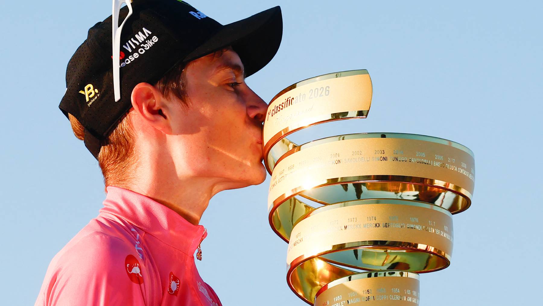 Team Visma Lease a Bike Danish rider Jonas Vingegaard wearing the overall leader's pink jersey kisses the trophy as he celebrates on the podium after winning the Giro d'Italia 2026 - Tour of Italy cycling race between Rome and Rome, Italy, on May 31, 2026.