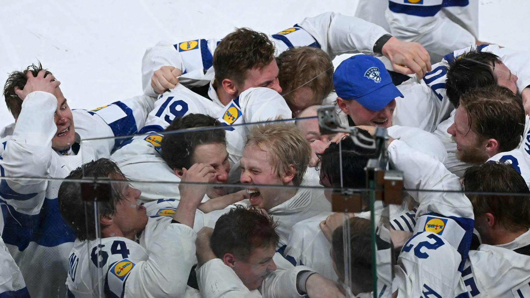 Finland's forward #94 Konsta Helenius (C) celebrates with teammates after scoring the sudden-death goal to win during the over time of the IIHF Ice Hockey Men's World Championship final match between Switzerland and Finland at the Swiss Life Arena in Zurich on May 31, 2026.