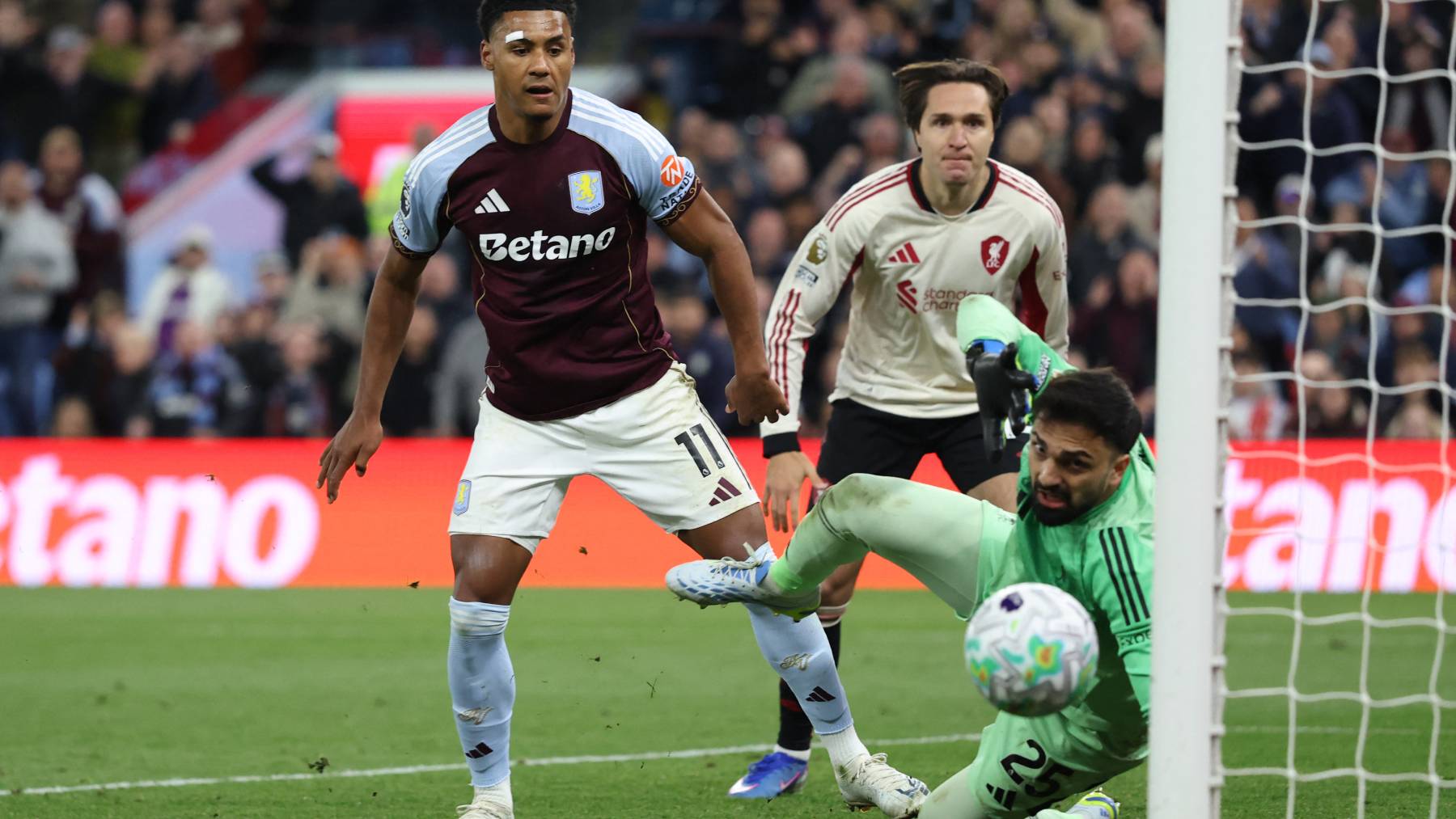 Aston Villa's English striker #11 Ollie Watkins (C) watches his shot beat Liverpool's Georgian goalkeeper #25 Giorgi Mamardashvili for their third goal during the English Premier League football match between Aston Villa and Liverpool at Villa Park in Birmingham, central England on May 15, 2026.