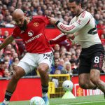 Manchester United's Cameroonian midfielder #19 Bryan Mbeumo (L) vies with Liverpool's Hungarian midfielder #08 Dominik Szoboszlai (R) during the English Premier League football match between Manchester United and Liverpool at Old Trafford in Manchester, north west England, on May 3, 2026.