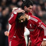 Liverpool's Hungarian midfielder #08 Dominik Szoboszlai (L) greets Liverpool's Egyptian forward #11 Mohamed Salah before a penalty kick during the UEFA Champions League, round of 16 second leg football match between Liverpool and Galatasaray at Anfield in Liverpool, north-west England on March 18, 2026.