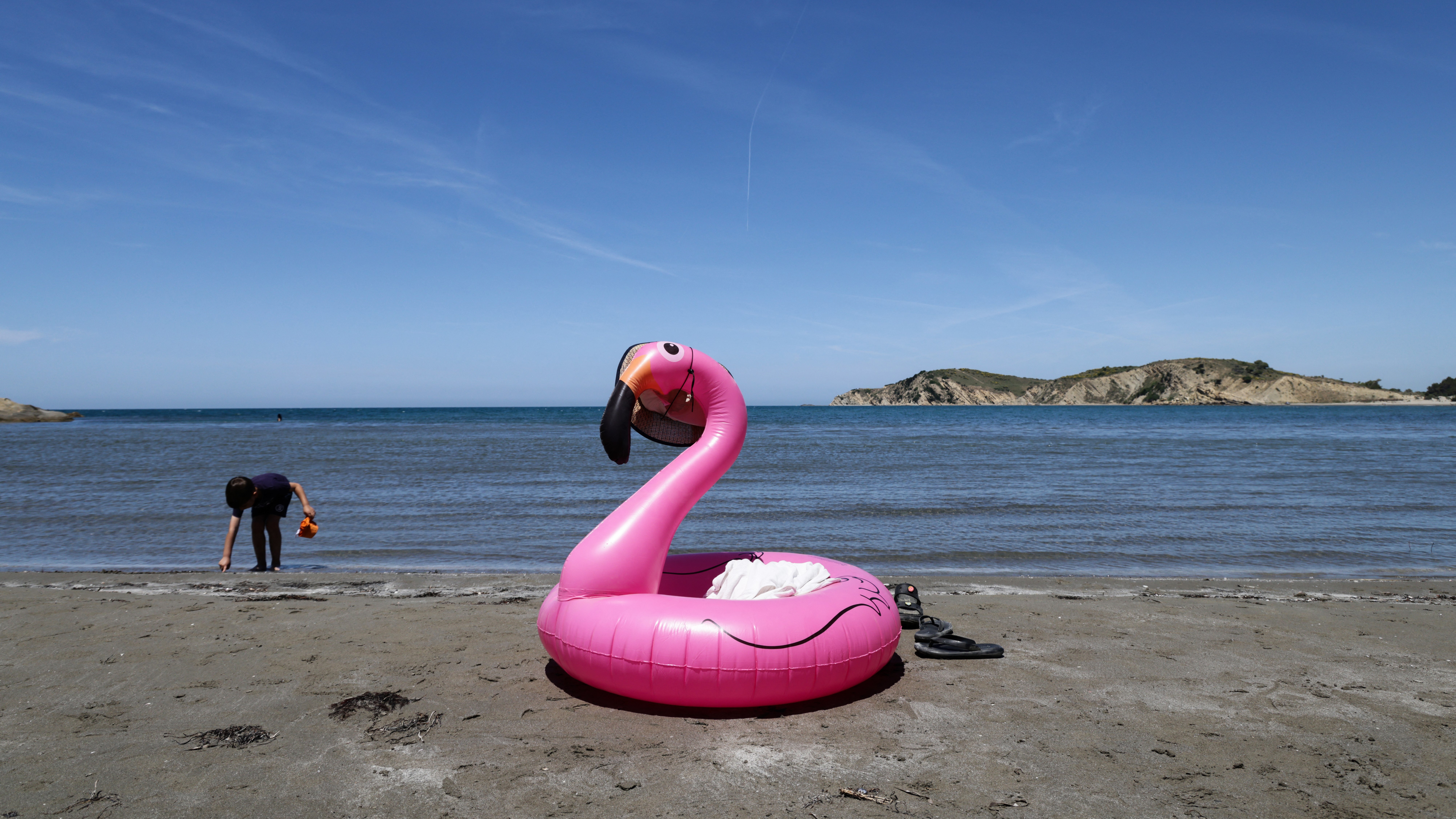 Protesters gather in Portonovo in Zvernec near Vlora, Albania, on June 6, 2026, during ongoing demonstrations against a proposed luxury tourism development project linked to Jared Kushner. Participants carry banners, flags, and symbolic flamingo imagery. (Photo by Vlasov Sulaj/NurPhoto) (Photo by Vlasov Sulaj / NurPhoto via AFP)
