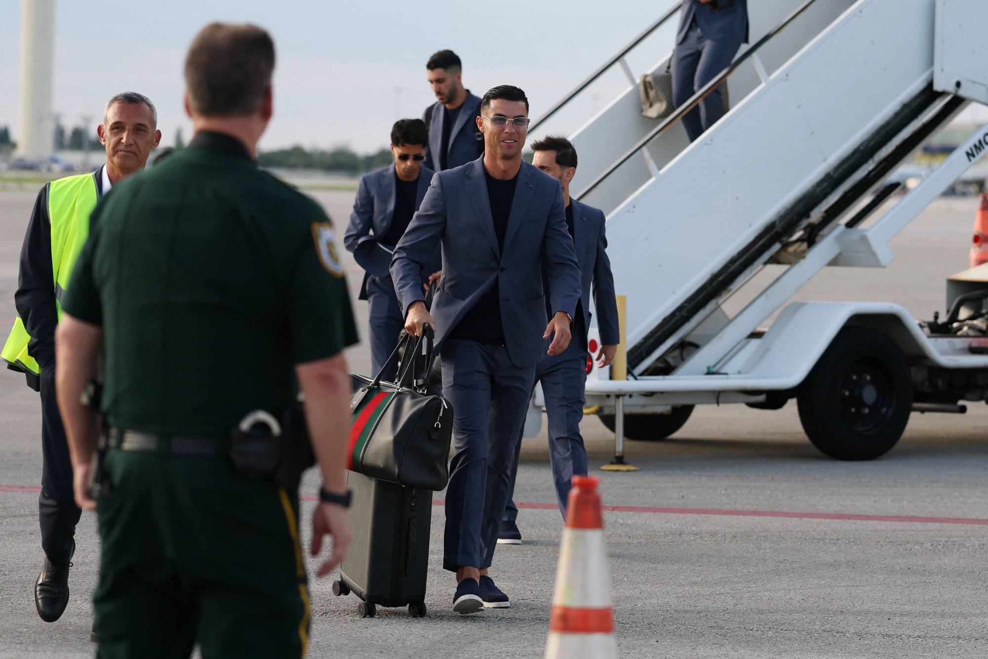 Portugal's forward #07 Cristiano Ronaldo (C) walks on the runway upon his arrival at the Palm Beach International Airport for the FIFA 2026 World Cup football tournament, in West Palm Beach, Florida on June 12, 2026.