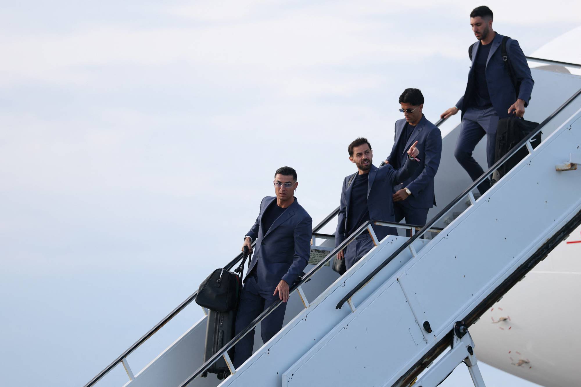 Portugal's forward #07 Cristiano Ronaldo (C) walks on the runway upon his arrival at the Palm Beach International Airport for the FIFA 2026 World Cup football tournament, in West Palm Beach, Florida on June 12, 2026.