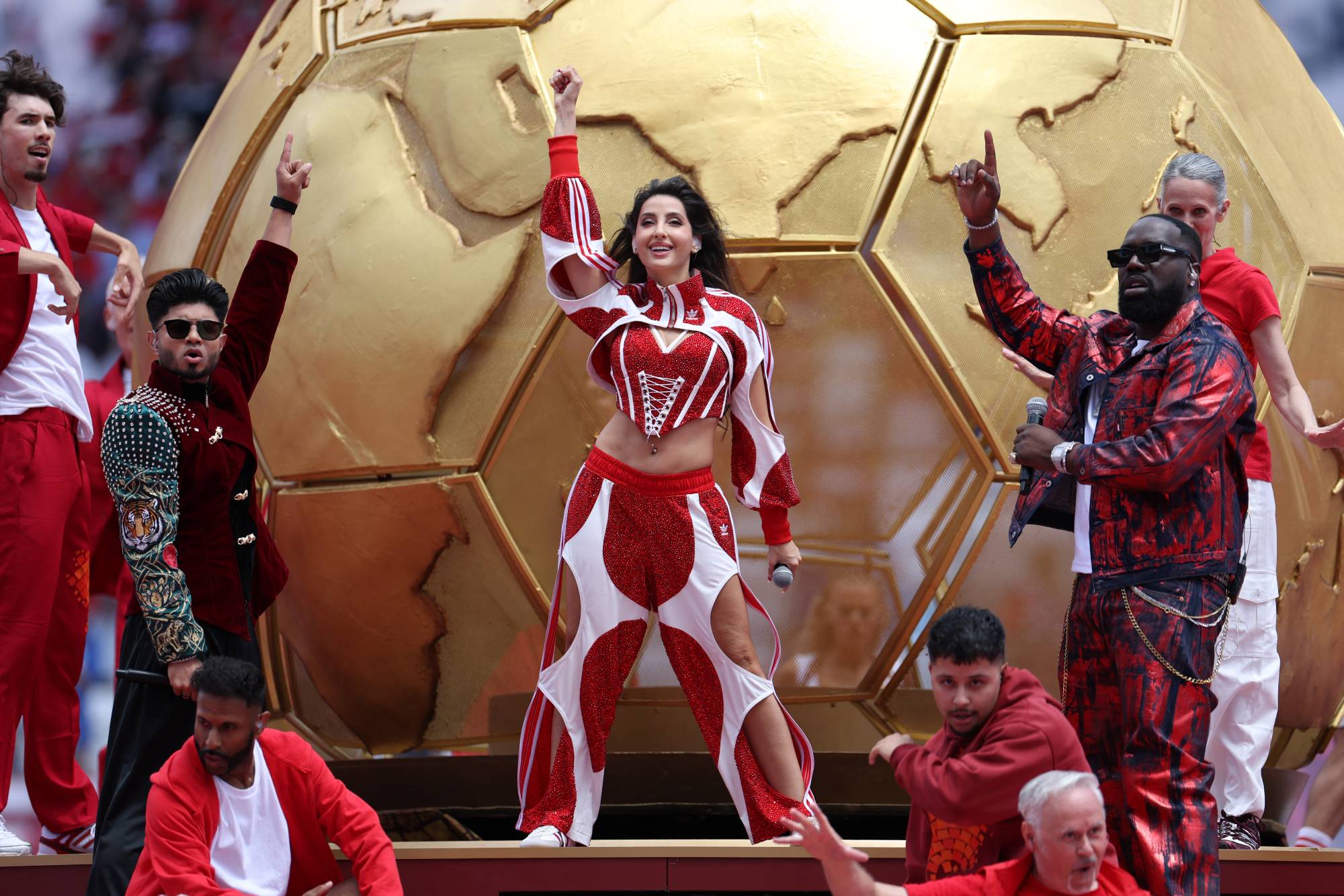 TORONTO, ONTARIO - JUNE 12: Sanjoy, Nora Fatehi and Vegedream perform during the Opening Ceremony before the FIFA World Cup 2026 Group B match between Canada and Bosnia and Herzegovina at Toronto Stadium on June 12, 2026 in Toronto, Ontario. Charlotte Wilson/Getty Images/AFP