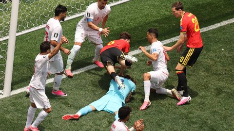 Iran's goalkeeper #01 Alireza Beiranvand makes a save past Belgium's defender #05 Maxim De Cuyper during the 2026 World Cup Group G football match between Belgium and Iran at the Los Angeles Stadium in Inglewood on June 21, 2026.