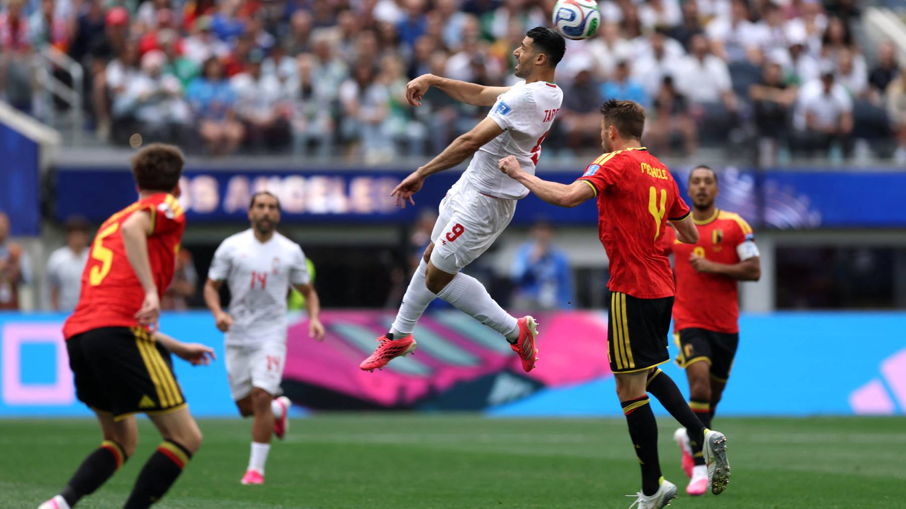 INGLEWOOD, CALIFORNIA - JUNE 21: Mehdi Taremi #9 of IR Iran and Brandon Mechele #4 of Belgium compete for the ball during the FIFA World Cup 2026 Group G match between Belgium and IR Iran at Los Angeles Stadium on June 21, 2026 in Inglewood, California. Jamie Squire/Getty Images/AFP
