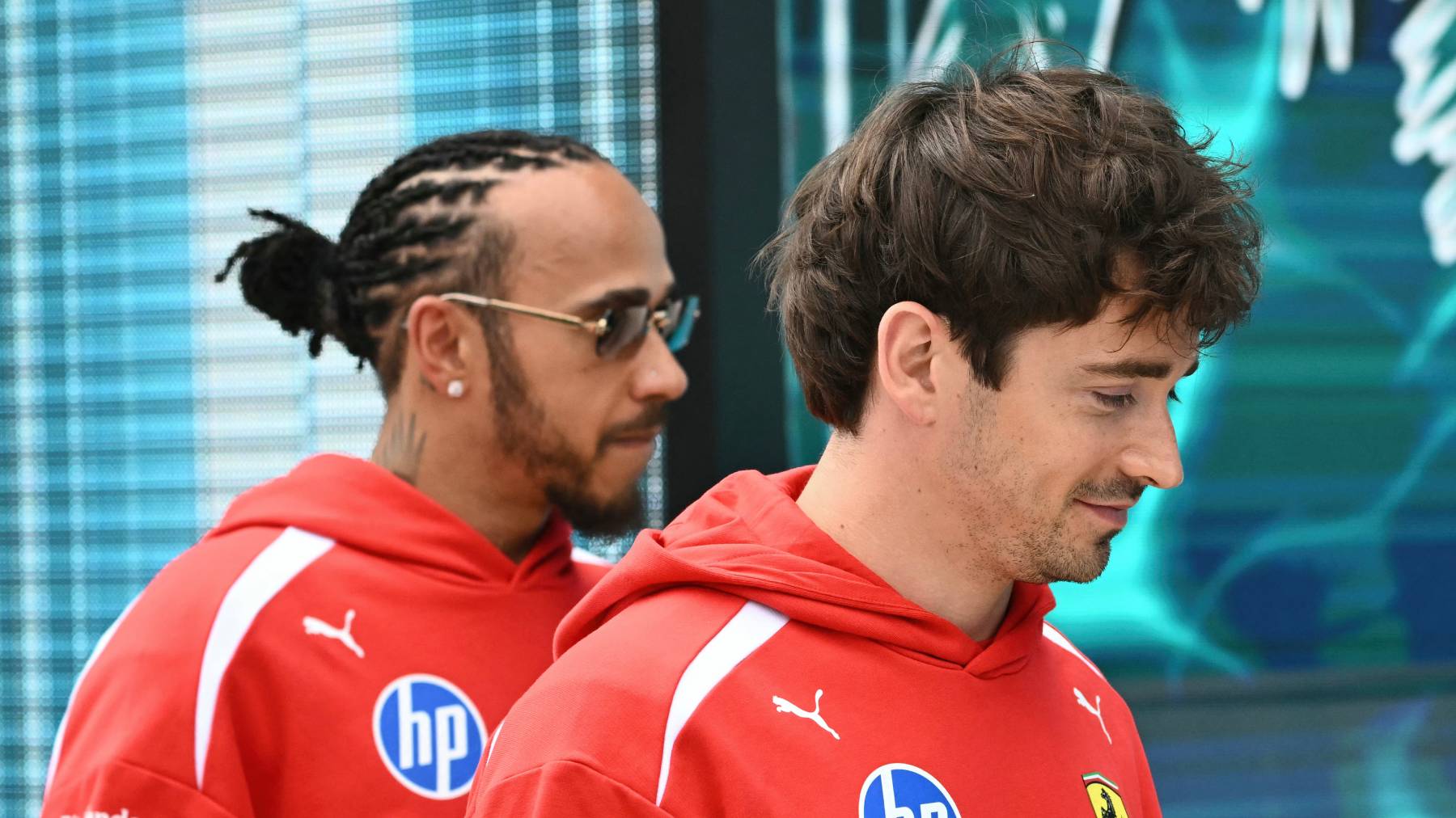 Ferrari's British driver Lewis Hamilton and Ferrari's Monegasque driver Charles Leclerc arrive for the Driver's Parade before the 2026 Miami Formula One Grand Prix at Miami International Autodrome in Miami Gardens, Florida, on May 3, 2026. Due to weather and timing, the Driver's Parade took place as a series of interviews near the garages instead of an on track parade.