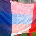A drenched French flag is held by fans watching the Group E match between France and Iraq at a watch party at Stateside Live! in Philadelphia, Pennsylvania, United States, on June 22, 2026. Attendees are warned to find shelter due to a lightning and thunderstorm, which delays the match at halftime at the nearby Philadelphia Stadium. (Photo by Bastiaan Slabbers/NurPhoto)