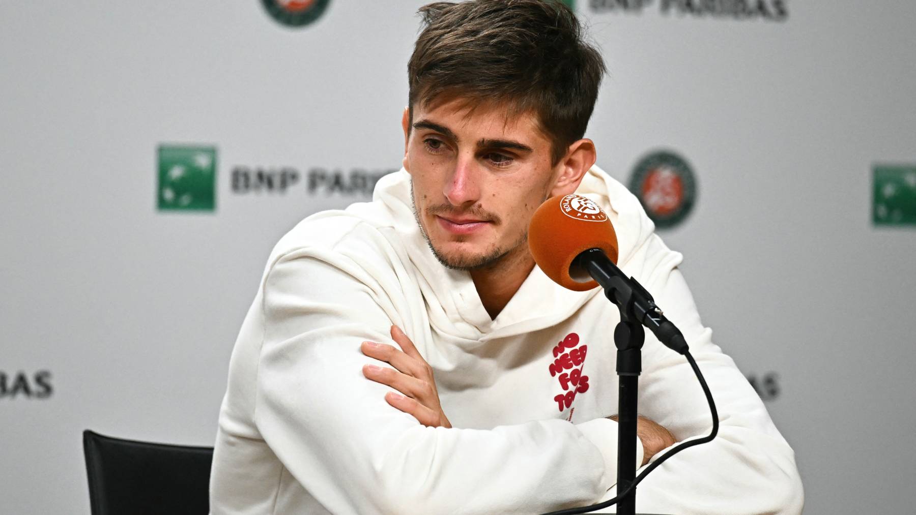 Italy's Matteo Arnaldi gives a press conference following his forfeit ahead of his men's semi final singles match against Italy's Flavio Cobolli on day 13 of the French Open tennis tournament on Court Philippe-Chatrier at the Roland-Garros Complex in Paris on June 5, 2026. Cobolli, the 10th seed, was due to be playing in his first Grand Slam semi-final but will instead benefit from some extra rest ahead of July 7's final.