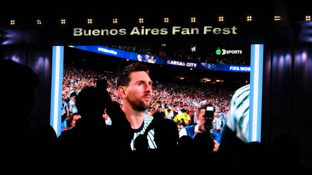 Fans watch on a giant screen, Argentina's forward Lionel Messi during the 2026 FIFA World Cup Group J football match between Argentina and Algeria, in Buenos Aires on June 16, 2026.