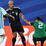 Polish referee Szymon Marciniak lifts Algeria's defender #02 Aissa Mandi as he reacts in pain next to Argentina's forward #10 Lionel Messi during the 2026 World Cup Group J football match between Argentina and Algeria at the Kansas City Stadium in Kansas City on June 16, 2026.