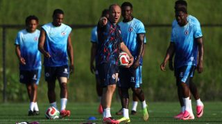 BOSTON, MASSACHUSETTS - JUNE 12: Sebastien Migne, Head Coach of Haiti, speaks with his players during the training and press conference of Haiti one day ahead of the FIFA World Cup 2026 Group C match between Haiti and Scotland at Boston Stadium on June 12, 2026 in Boston, Massachusetts. Mattia Ozbot/Getty Images/AFP