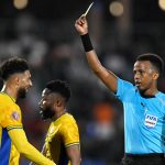 Gabon's forward #20 Denis Bouanga is shown the yellow card by Somali referee Omar Abdulkadir Artan during the Africa Cup of Nations (CAN) Group F football match between Gabon and Ivory Coast at the Grand Stadium in Marrakech on December 31, 2025. Award-winning Somali referee Omar Artan, set to be the first from his country to officiate at the World Cup, was denied entry to the United States, a sports ministry official told AFP on June 8, 2026. "Denying him entry to the United States and preventing him from officiating scheduled matches harms not only him personally but also undermines football's commitment to fairness, merit, and the spirit of fair play," Ciise Aden Abshir, a senior advisor to Somalia's Ministry of Youth and Sports and a former national team captain, told AFP.