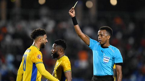 Gabon's forward #20 Denis Bouanga is shown the yellow card by Somali referee Omar Abdulkadir Artan during the Africa Cup of Nations (CAN) Group F football match between Gabon and Ivory Coast at the Grand Stadium in Marrakech on December 31, 2025. Award-winning Somali referee Omar Artan, set to be the first from his country to officiate at the World Cup, was denied entry to the United States, a sports ministry official told AFP on June 8, 2026. "Denying him entry to the United States and preventing him from officiating scheduled matches harms not only him personally but also undermines football's commitment to fairness, merit, and the spirit of fair play," Ciise Aden Abshir, a senior advisor to Somalia's Ministry of Youth and Sports and a former national team captain, told AFP.