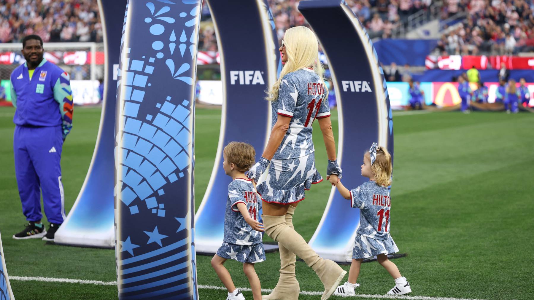 NGLEWOOD, CALIFORNIA - JUNE 25: Paris Hilton and her children Phoenix Hilton-Reum and London Hilton-Reum are seen before the FIFA World Cup 2026 Group D match between Türkiye and USA at Los Angeles Stadium on June 25, 2026 in Inglewood, California. Emilee Chinn/Getty Images/AFP