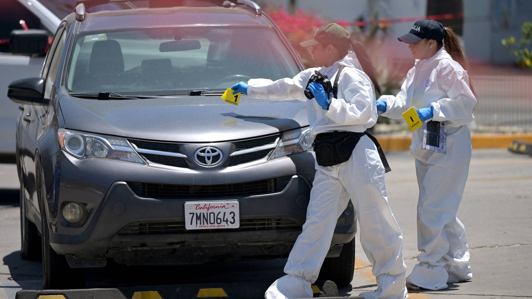 Forensic workers inspect a car where a body was allegedly found at a parking lot close to Caliente stadium, where Iran's national football team trains, in Tijuana, Baja California, Mexico on June 12, 2026.