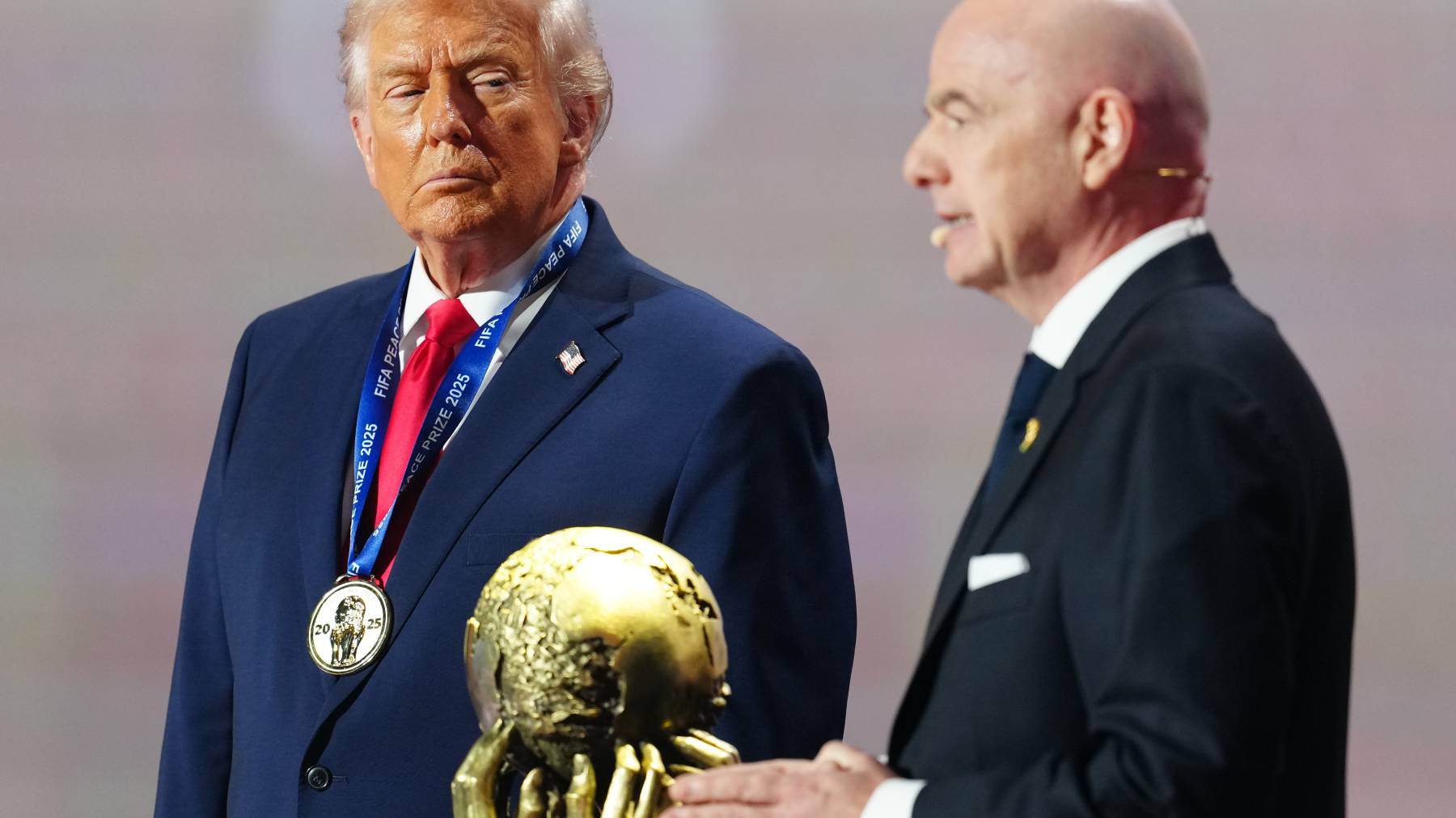 WASHINGTON, DC - DECEMBER 05: U.S. President Donald Trump receives the FIFA Peace Prize from Gianni Infantino, President of FIFA, during the FIFA World Cup 2026 Official Draw at John F. Kennedy Center for the Performing Arts on December 05, 2025 in Washington, DC. (Photo by Jia Haocheng - Pool/Getty Images)