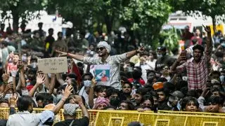 Cockroach Janta Party (CJP) supporters celebrate the resignation of India's Education Minister Dharmendra Pradhan, at Jantar Mantar in New Delhi on July 25, 2026 amid the ongoing protests over alleged NEET exam irregularities. India's education minister Dharmendra Pradhan resigned on July 25, after mass youth-led protests demanded his ouster in anger over a string of irregularities in potentially life-changing exams. (Photo by Arun SANKAR / AFP)