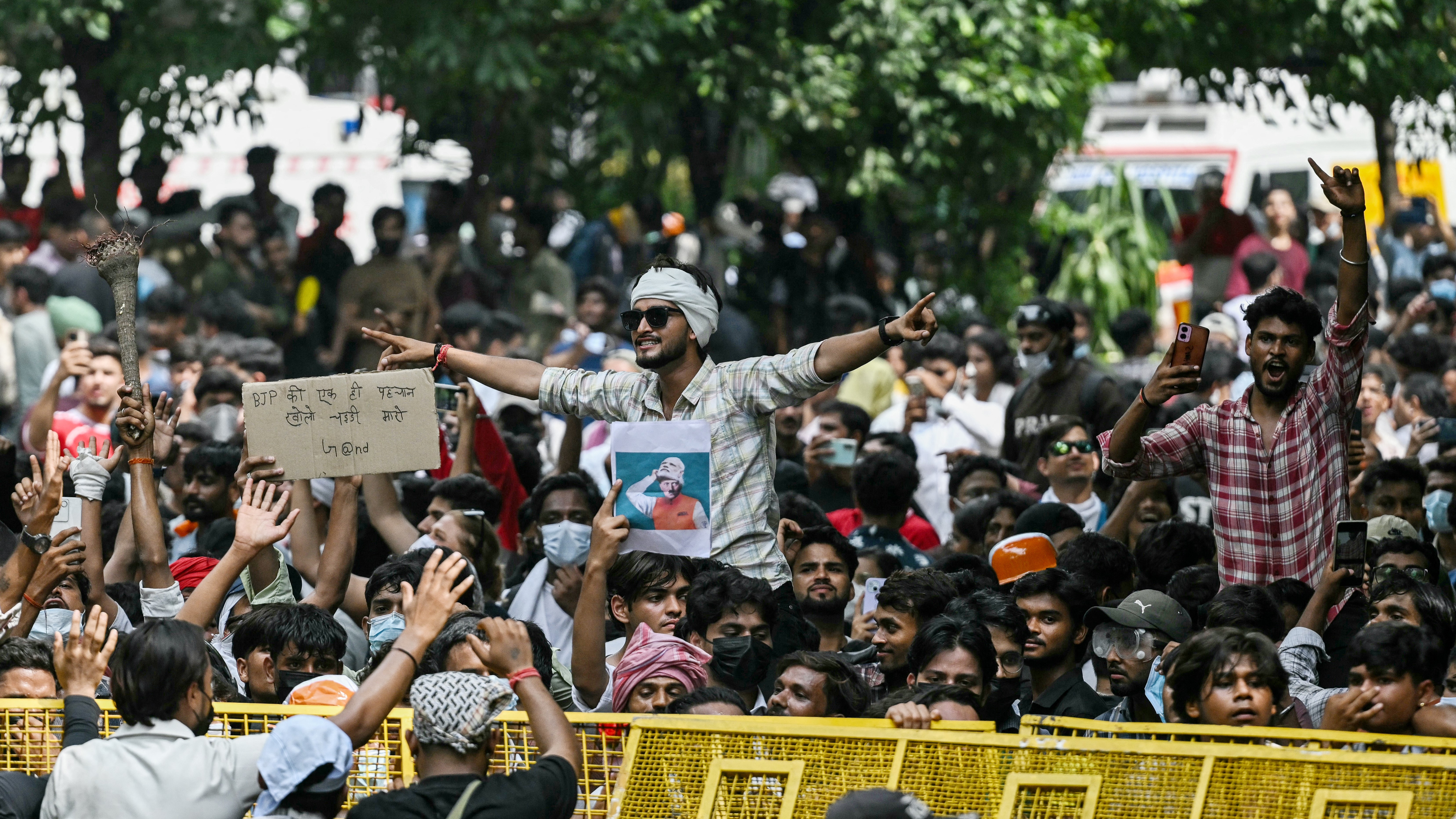 Cockroach Janta Party (CJP) supporters celebrate the resignation of India's Education Minister Dharmendra Pradhan, at Jantar Mantar in New Delhi on July 25, 2026 amid the ongoing protests over alleged NEET exam irregularities. India's education minister Dharmendra Pradhan resigned on July 25, after mass youth-led protests demanded his ouster in anger over a string of irregularities in potentially life-changing exams. (Photo by Arun SANKAR / AFP)