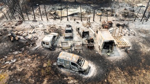 This aerial view shows burnt cars following a wildfire in Le Porge, in the Gironde Department, south-western France on July 25, 2026. The fires, which are on an unprecedented scale and have forced the evacuation of around 200,000 "fire refugees" in Gironde and the Landes, were still not under control on July 25, 2026 and continue to keep firefighters and military personnel on high alert, including an A400M aircraft deployed to tackle the blaze for the first time. (Photo by Florian PLAUCHEUR / AFP)