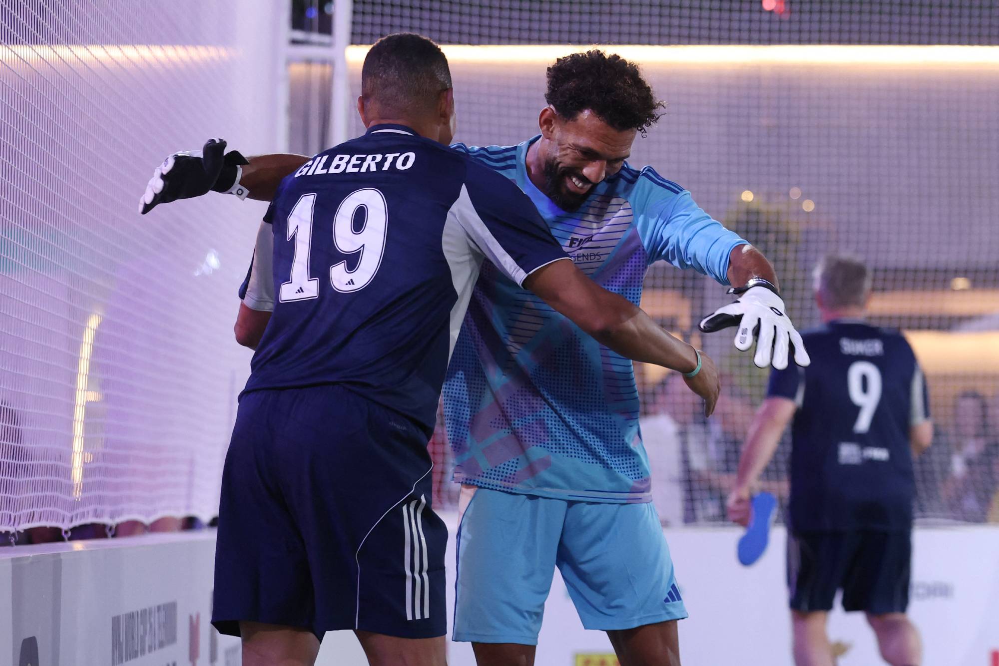 NEW YORK, NEW YORK - JULY 17: Vozinha of FIFA Legends Blue Team celebrates with Gilberto Silva during the FIFA Legends Cup at Rockefeller Center on July 17, 2026 in New York City. Carl Recine/Getty Images/AFP