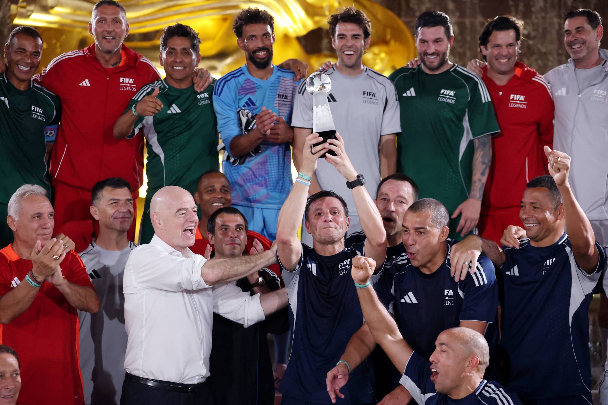 NEW YORK, NEW YORK - JULY 17: Javier Zanetti of FIFA Legends blue team lifts the trophy as Gianni Infantino, FIFA President celebrates during the FIFA Legends Cup at Rockefeller Center on July 17, 2026 in New York City. Carl Recine/Getty Images/AFP