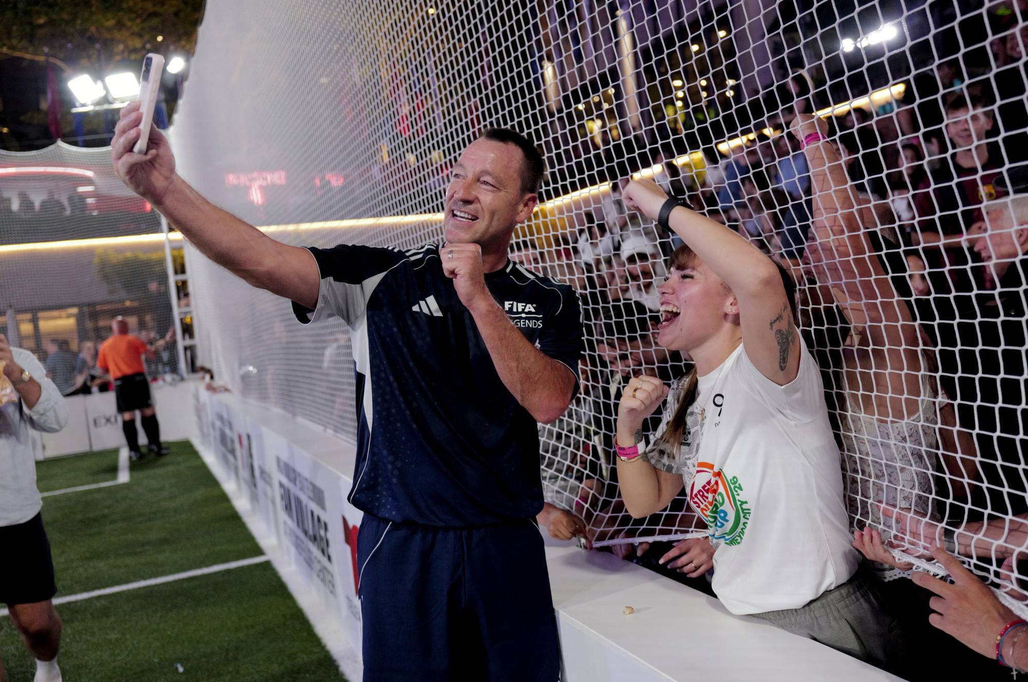 NEW YORK, NEW YORK - JULY 17: John Terry poses with a fan during the FIFA Legends Match at the NYNJ World Cup 26 & Telemundo Fan Village at Rockefeller Center on July 17, 2026 in New York City. Craig Barritt/Getty Images for Rockefeller Center/AFP