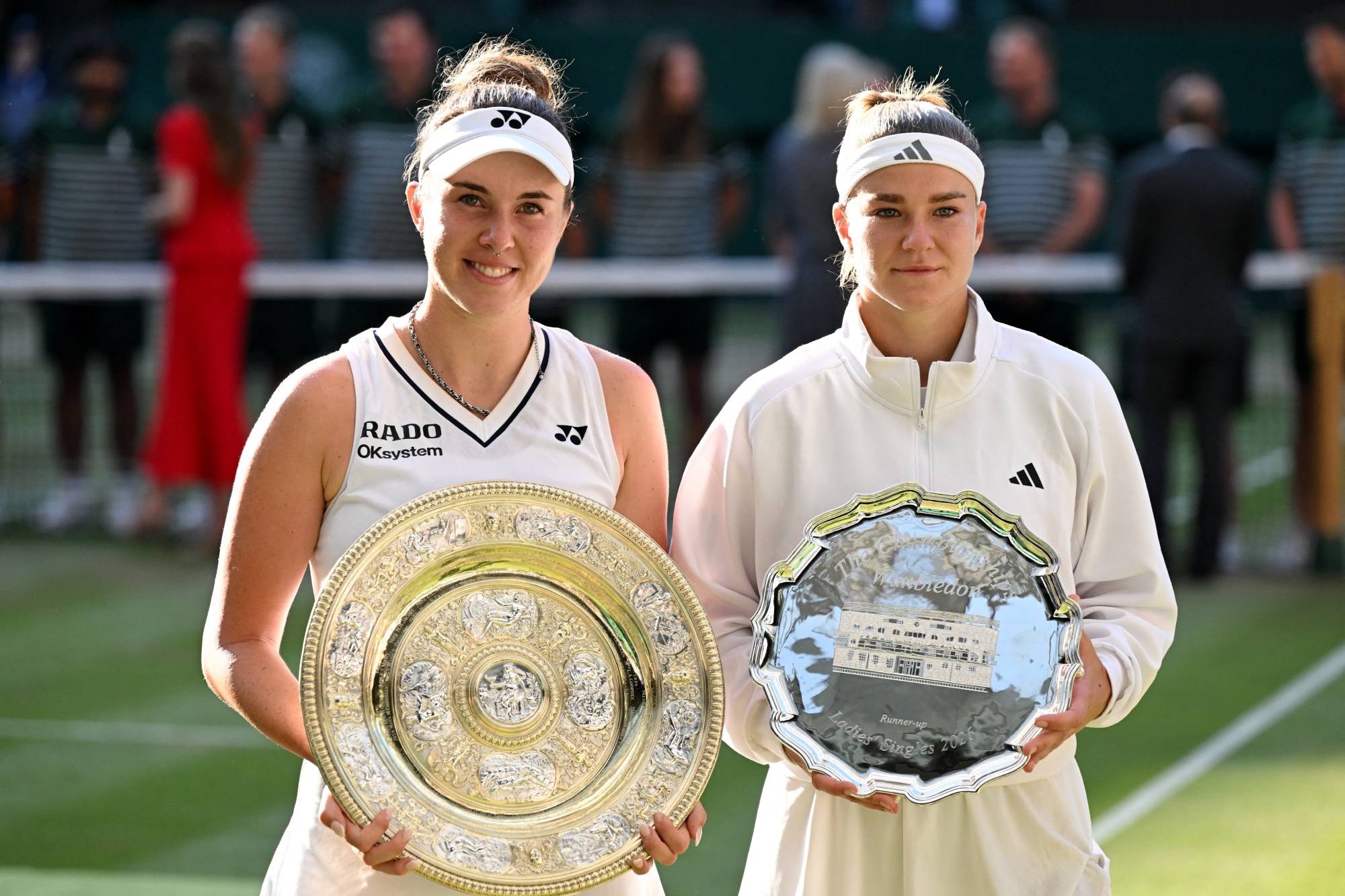 Czech Republic's Linda Noskova (L) poses with the winner's trophy, the Venus Rosewater Dish, after winning against Czech Republic's Karolina Muchova during their women's singles final tennis match on the thirteenth day of the 2026 Wimbledon Championships at The All England Lawn Tennis and Croquet Club in Wimbledon, southwest London, on July 11, 2026.