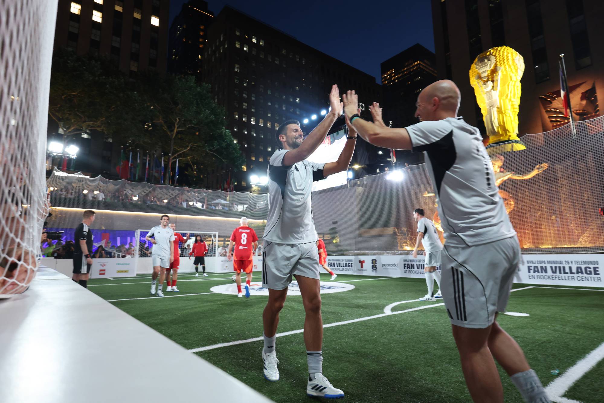 NEW YORK, NEW YORK - JULY 17: Novak Djokovic and Esteban Cambiasso of FIFA Legends grey team react together during the FIFA Legends Cup at Rockefeller Center on July 17, 2026 in New York City. (Photo by Ryan Pierse - FIFA/FIFA via Getty Images)