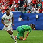 England's midfielder #10 Jude Bellingham runs past Norway's goalkeeper #01 Orjan Nyland after scoring his team's second goal during the 2026 World Cup football tournament quarter-final match between Norway and England at Miami Stadium in Miami on July 11, 2026.