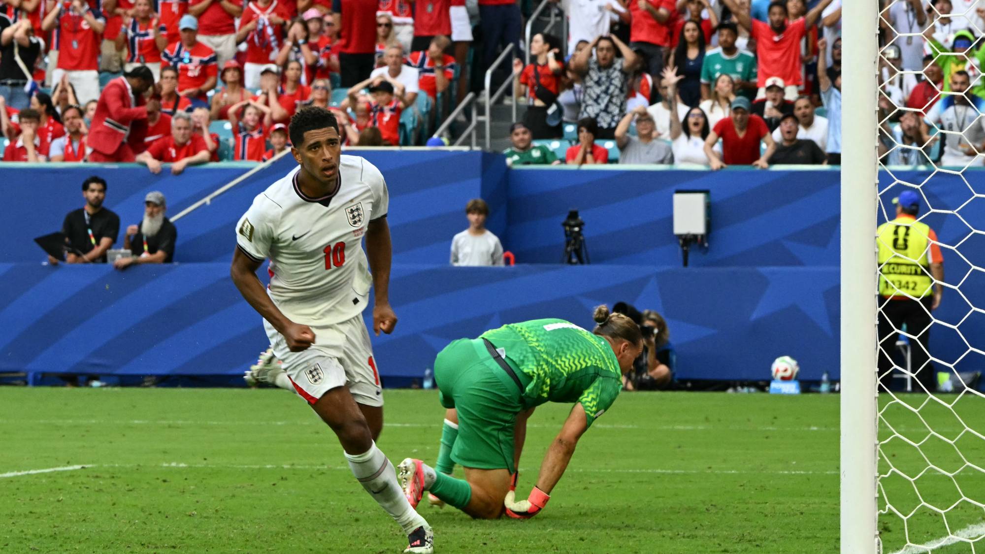 England's midfielder #10 Jude Bellingham runs past Norway's goalkeeper #01 Orjan Nyland after scoring his team's second goal during the 2026 World Cup football tournament quarter-final match between Norway and England at Miami Stadium in Miami on July 11, 2026.