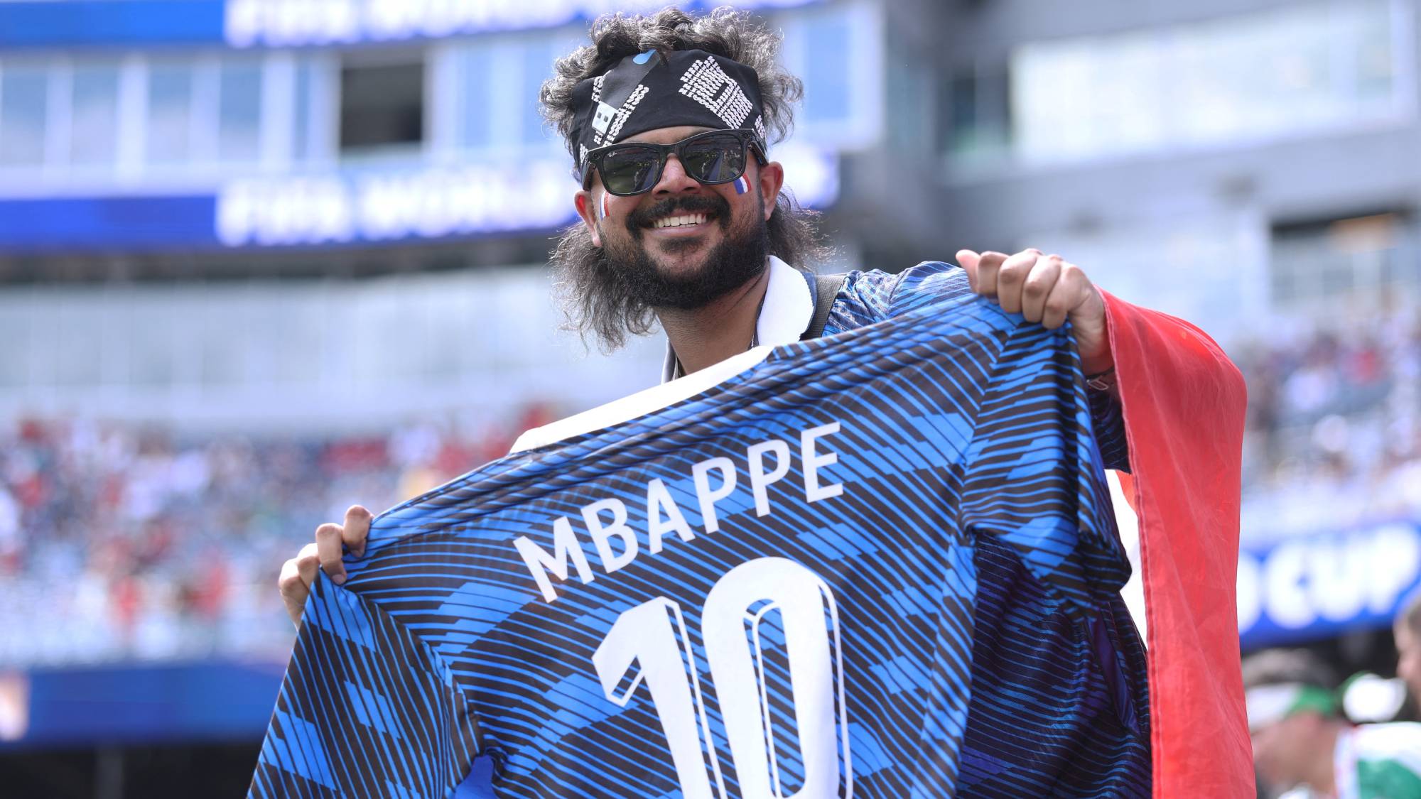 FOXBOROUGH, MASSACHUSETTS - JULY 09: A France fan poses for photos before the FIFA World Cup 2026 Quarter Final match between France and Morocco at Boston Stadium on July 09, 2026 in Foxborough, Massachusetts. Lars Baron/Getty Images/AFP
