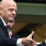 FIFA President Gianni Infantino (L) throws a replica match ball into the crowd at the end of the 2026 World Cup football tournament semi-final match between France and Spain at the Dallas Stadium in Arlington on July 14, 2026.